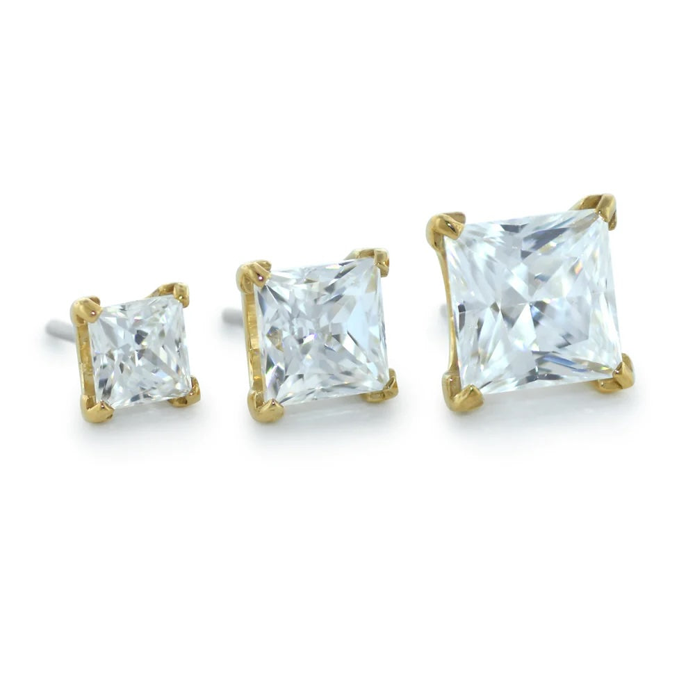 Neometal Gold earrings with clear gemstones on a white background