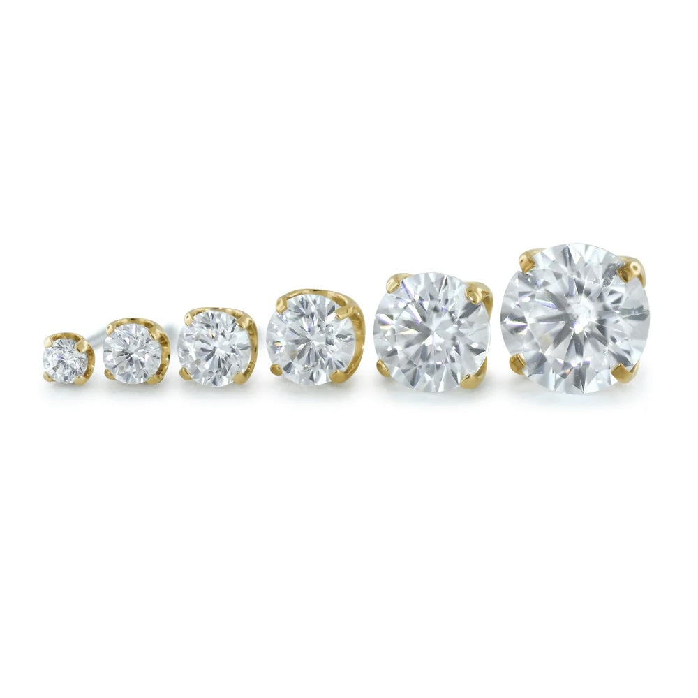 Set of Neometal diamond earrings with gold and silver settings on a white background