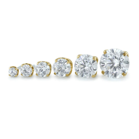 Set of Neometal diamond earrings with gold and silver settings on a white background