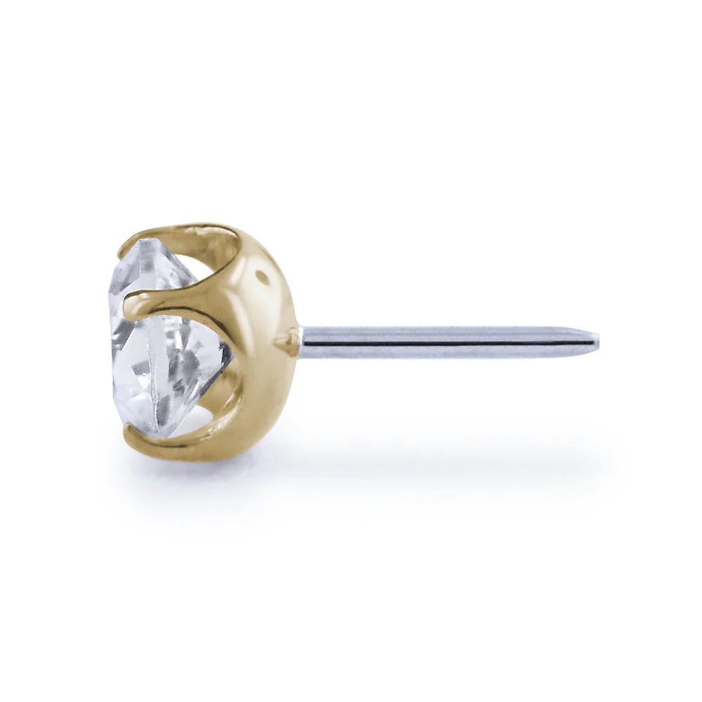 Gold and silver nose ring with a clear gemstone on a white background