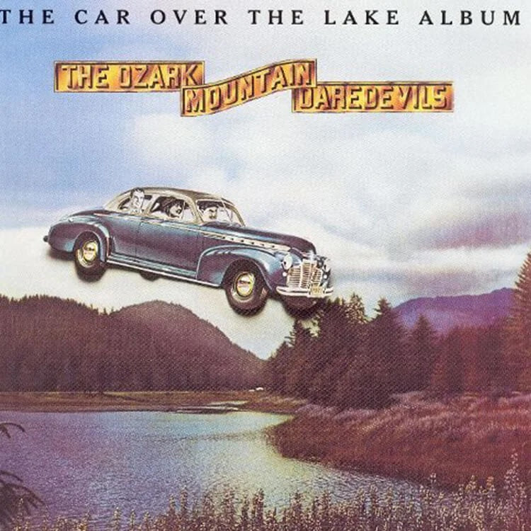 Album cover with a car flying over a lake and mountains, featuring text 'The Car Over the Lake Album' and 'The Ozark Mountain Daredevils'.